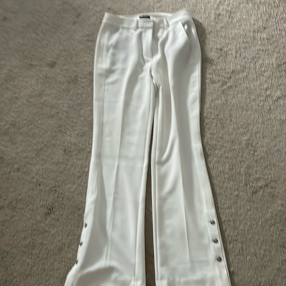 The limited ivory flare pants with button detail